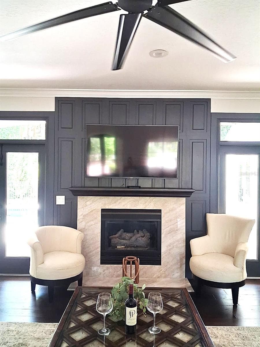 Gas Fireplace totally re imagined & now surrounded by Taj Mahal Marble and Floor to Ceiling Paneled Feature Wall. New Very Lg Fan - 3171 DICK WILSON DR, SARASOTA