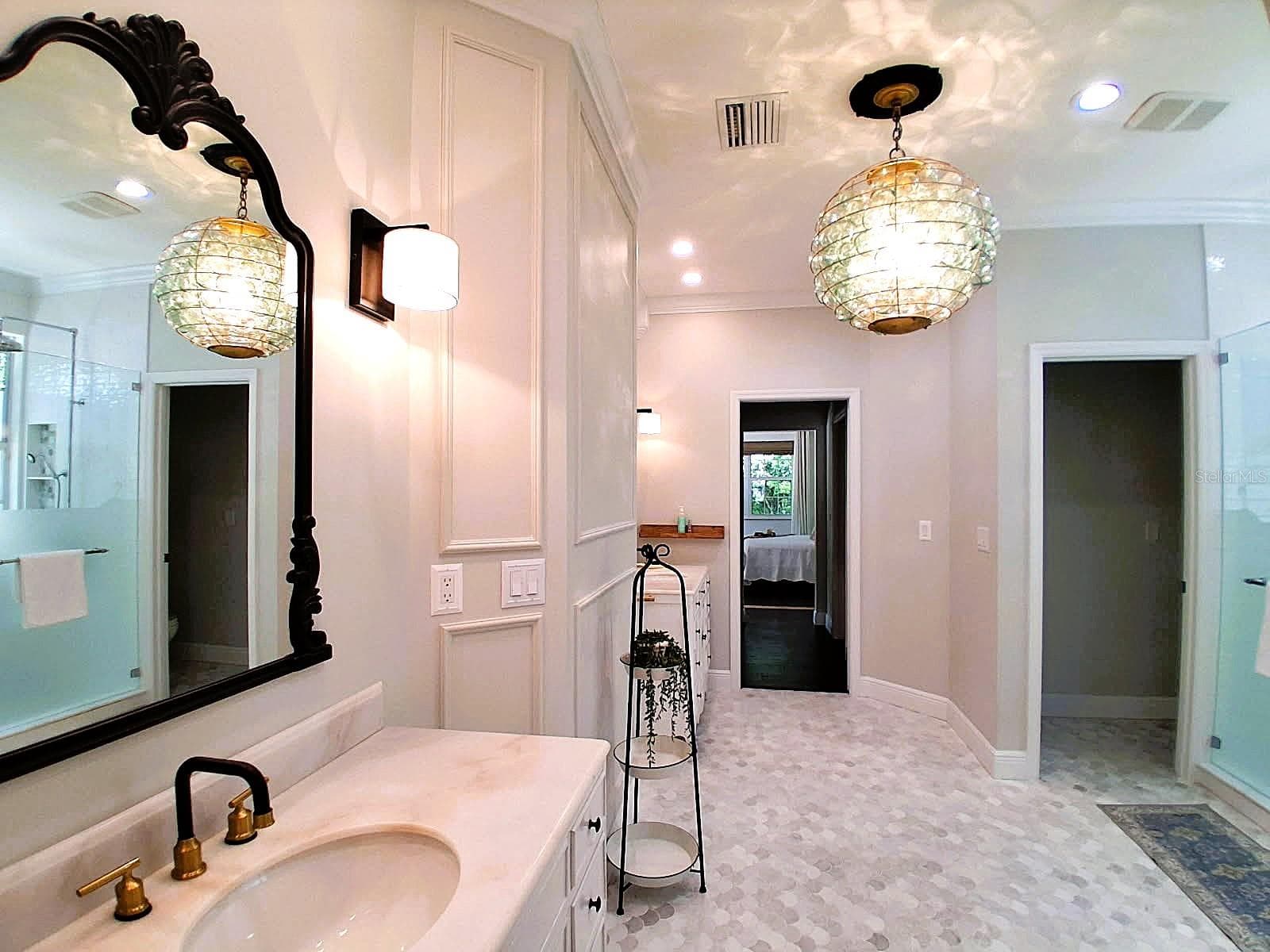 MasterBath stunning remodel in Marble with Double Vanity Sinks, Marble Scallop Flooring, New Molding on Walls & Ceiling, New Stunning Custom Glass Light Fixture. 2 Separate Toilet Rooms. New Lg Walk In shower with Restoration Harware Fixtures accesible by both downstairs bedrooms - 3171 DICK WILSON DR, SARASOTA