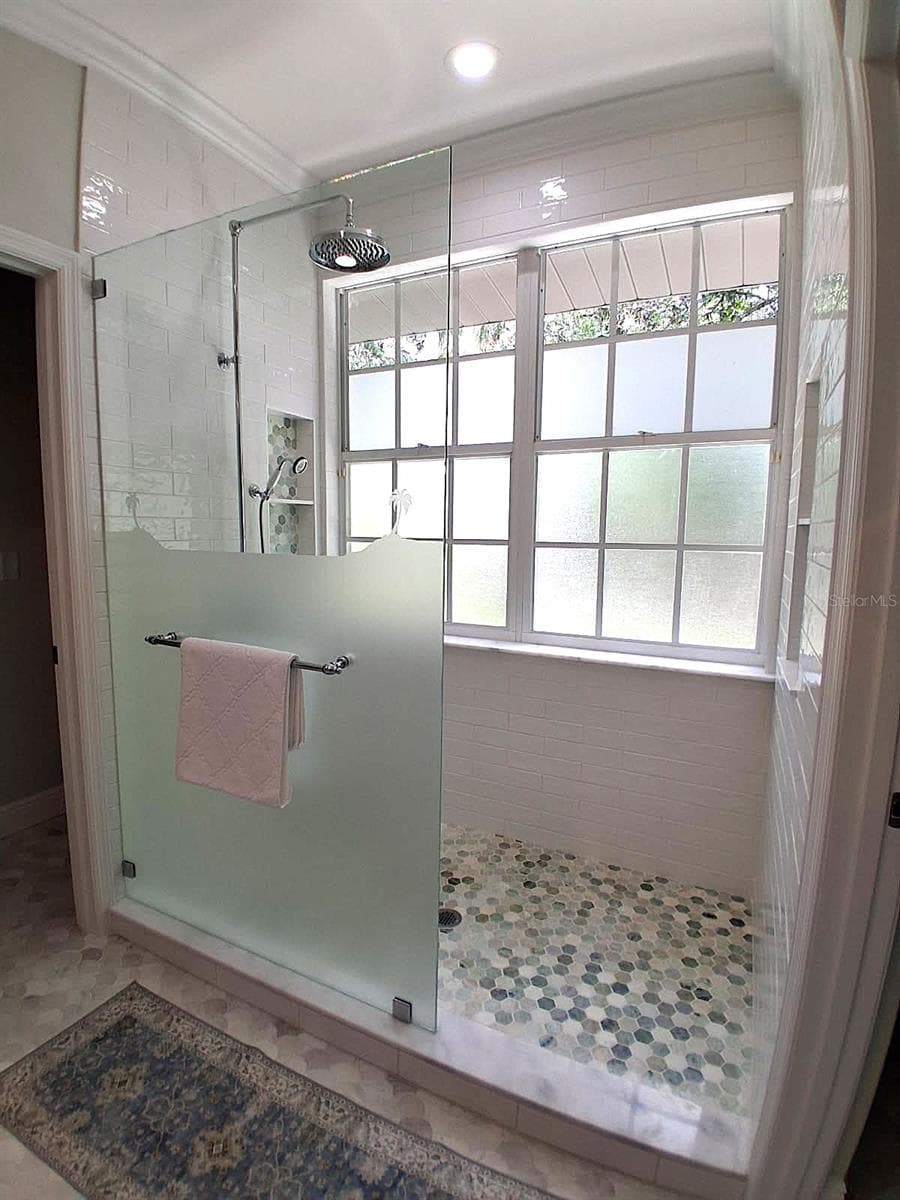 New Large Shower with large window . Lots of Natural light. Marble floors, New floor to ceiling Subway Tile. Built in shelves on both walls plus x lg window shelf for extra storage. Every detail has been thought of - 3171 DICK WILSON DR, SARASOTA