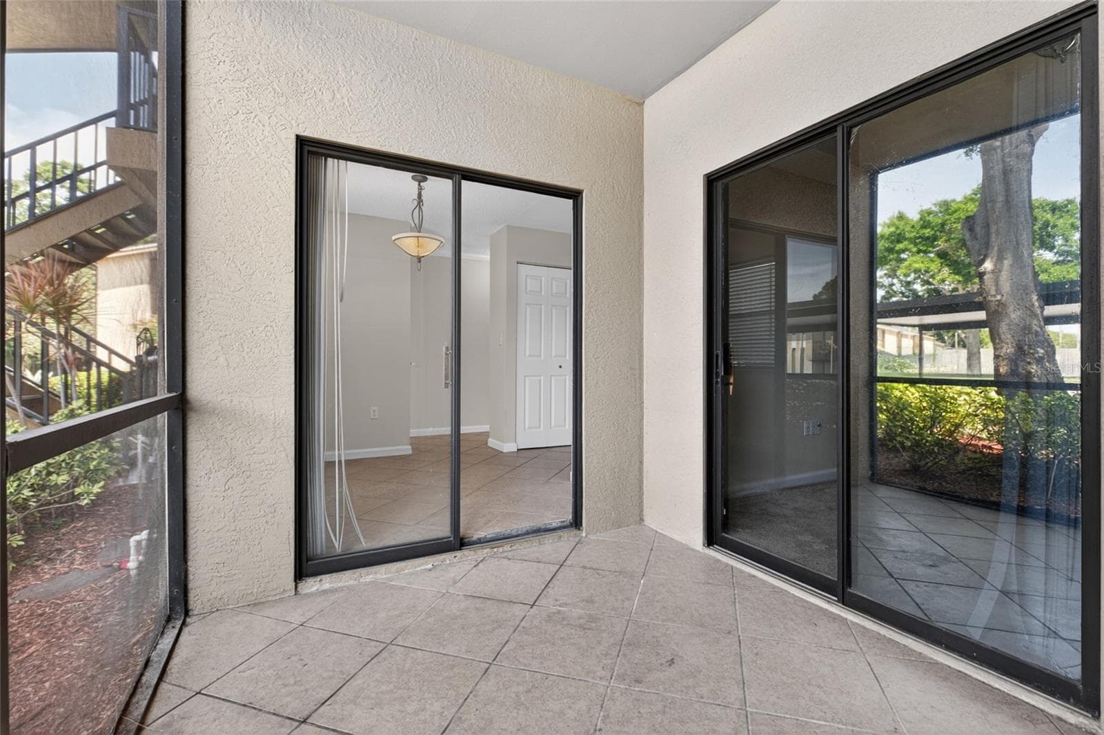 The front lanai has sliders that lead to the dining room and the front bedroom. - 10125 SAILWINDS BLVD N #104, LARGO