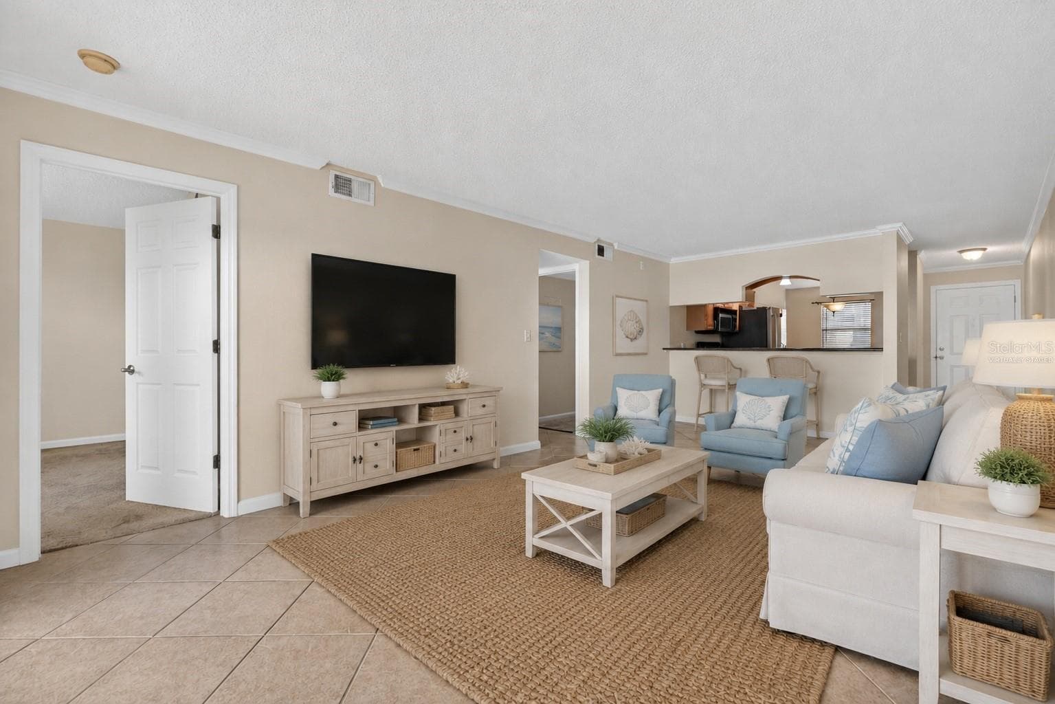 Virtually staged living room. - 10125 SAILWINDS BLVD N #104, LARGO
