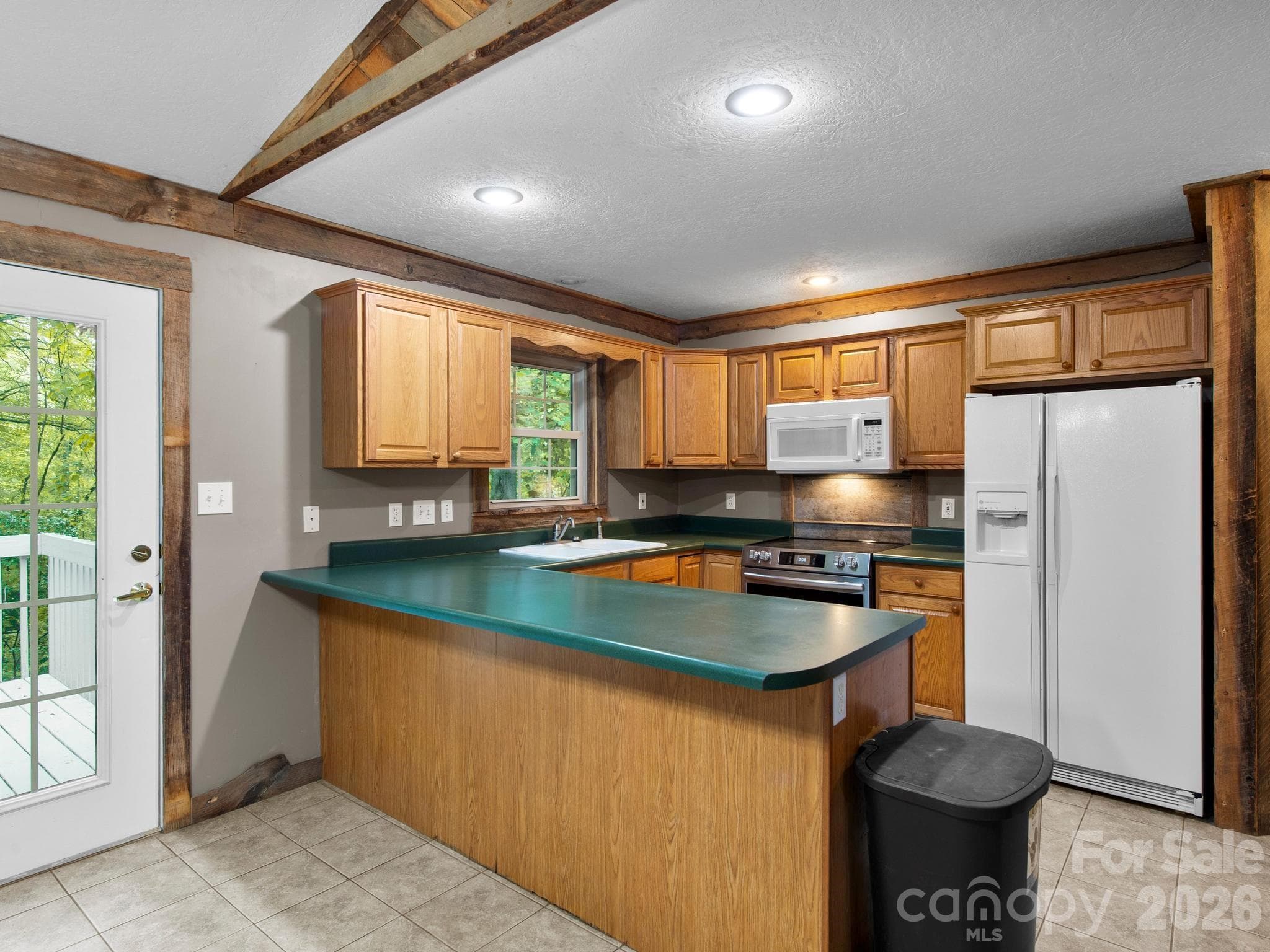 Very functional kitchen looking out to rear deck and wooded lot - 37 Leatherwood Drive, Candler
