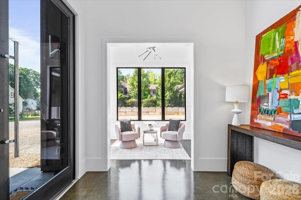 Enter through a 9'x4' self closing front door into a large and bright foyer with 25' ceiling - Charlotte