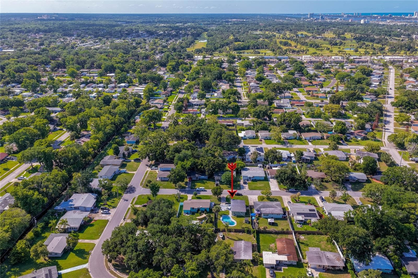 Wide-angle regional aerial highlighting the home's proximity to surrounding coastal areas, golf courses, and local community amenities. - 723 STEELE AVE, SOUTH DAYTONA