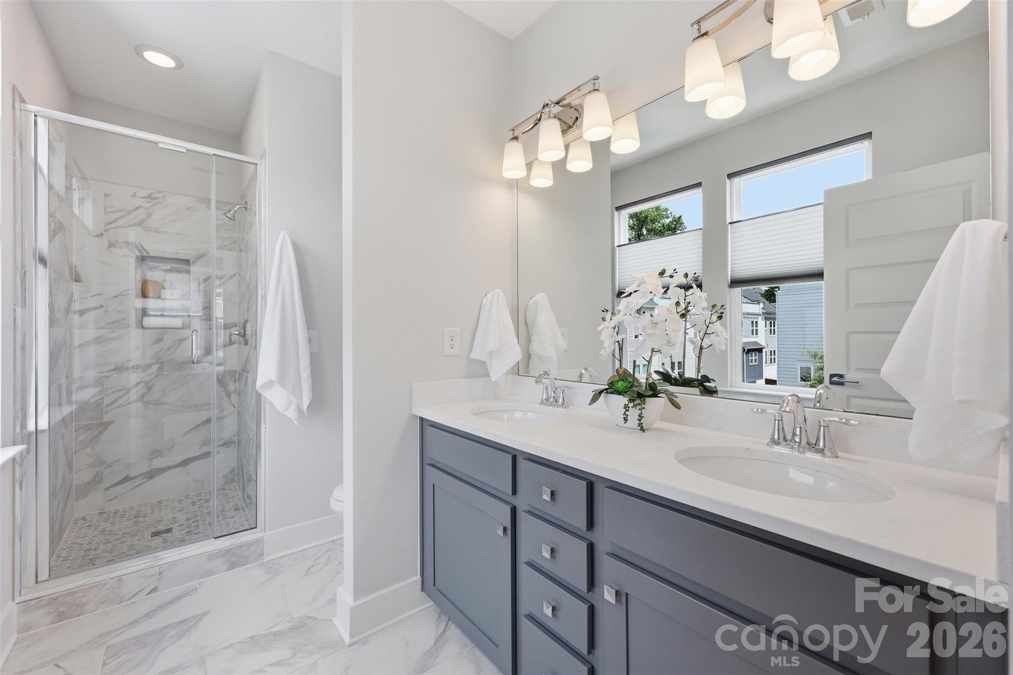 Dual vanity sinks and a large shower in the primary bath. - 2148 Electric Lane, Charlotte