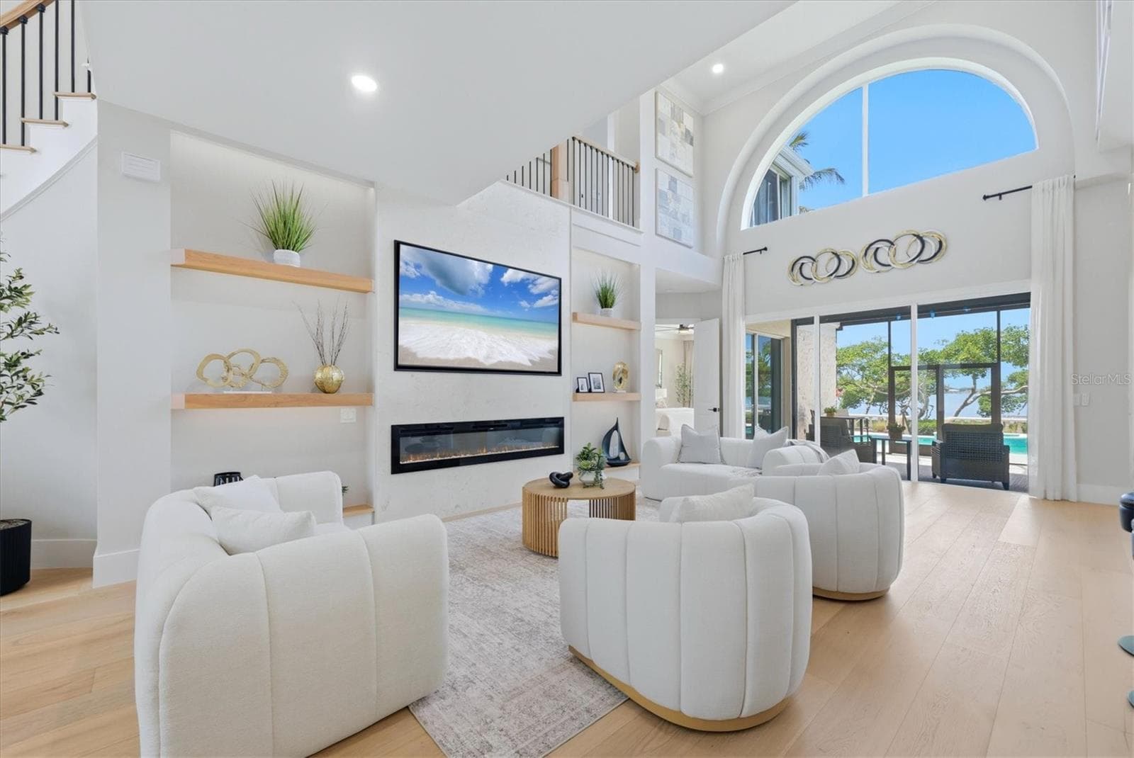 Family Room with Feature Wall including Electric Fireplace, Built-in Shelving and Lighting - 3606 FAIR OAKS PL, LONGBOAT KEY