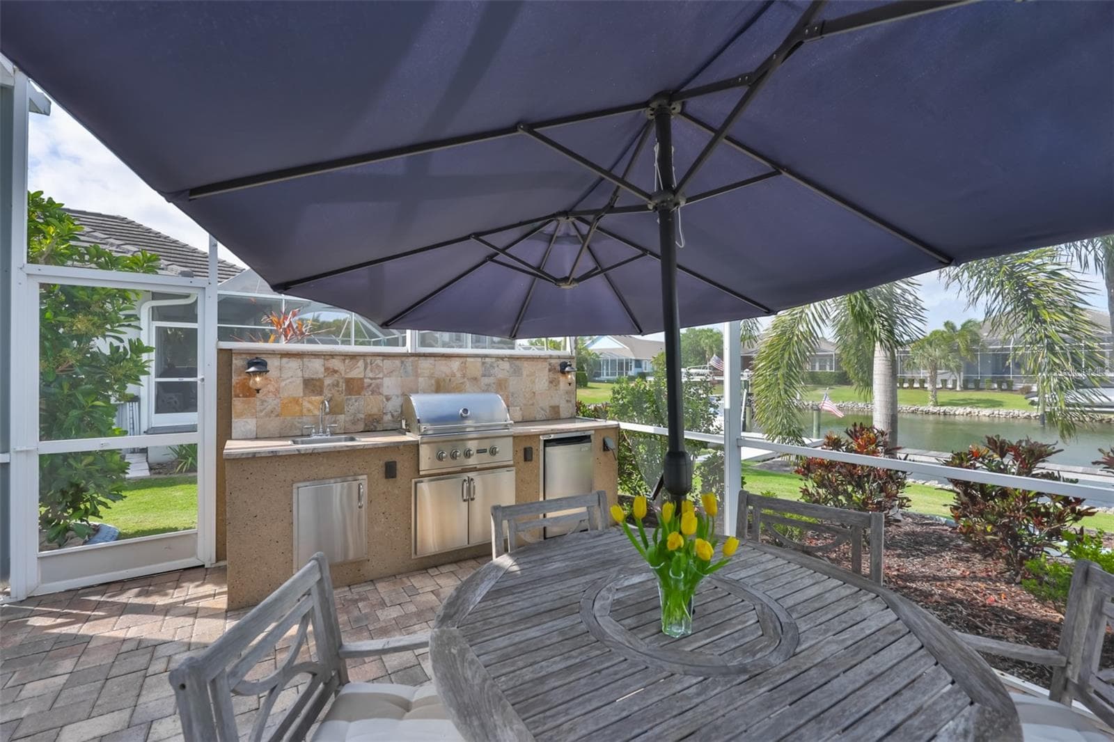 outdoor kitchen with sink, refrigerator, and gas grill - 5318 LOON NEST CT, APOLLO BEACH