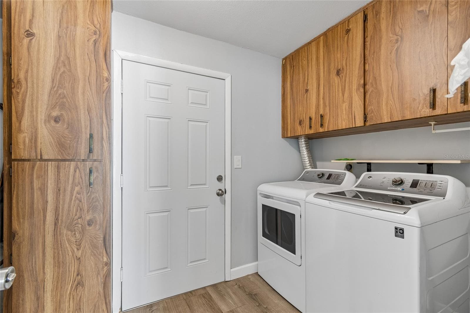 Laundry Room with Exterior Access & Storage - 7324 STONE HAVEN CT N, PINELLAS PARK