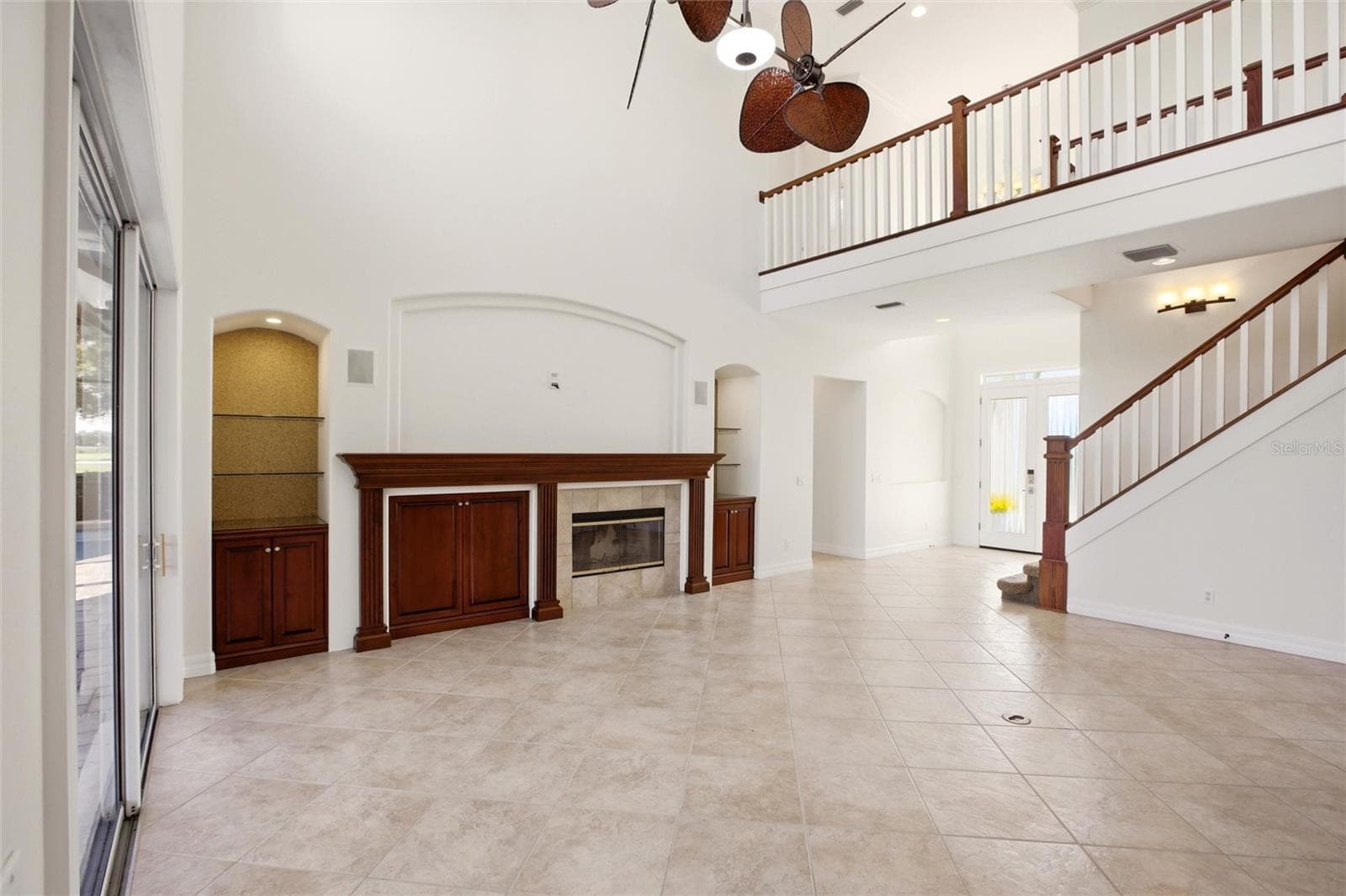 The family room features soaring cathedral ceilings, a fireplace with mantel, and sliding glass doors opening to the lanai, while flowing seamlessly into the kitchen for comfortable everyday living and entertaining. - 8417 LONE EAGLE WAY, SARASOTA