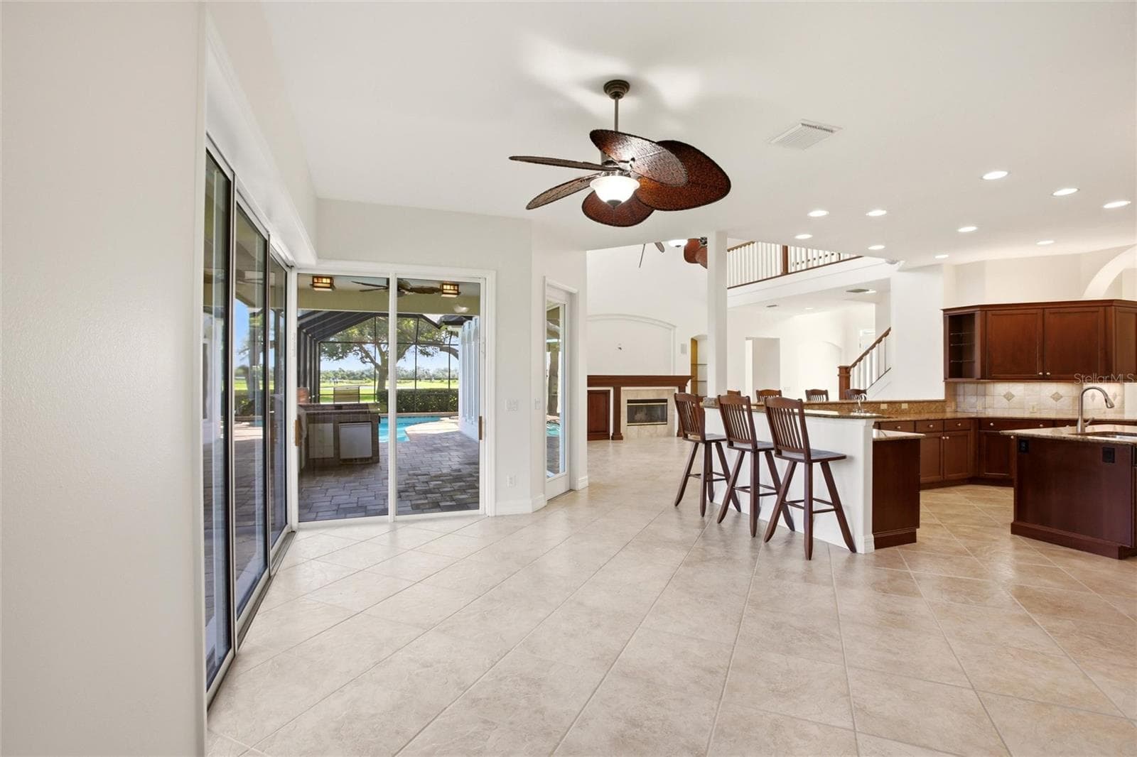 The kitchen offers an extensive breakfast bar and a comfortable casual dining area, along with generous counter space, dual sinks, double ovens, abundant cabinetry, and a spacious walk-in pantry. - 8417 LONE EAGLE WAY, SARASOTA