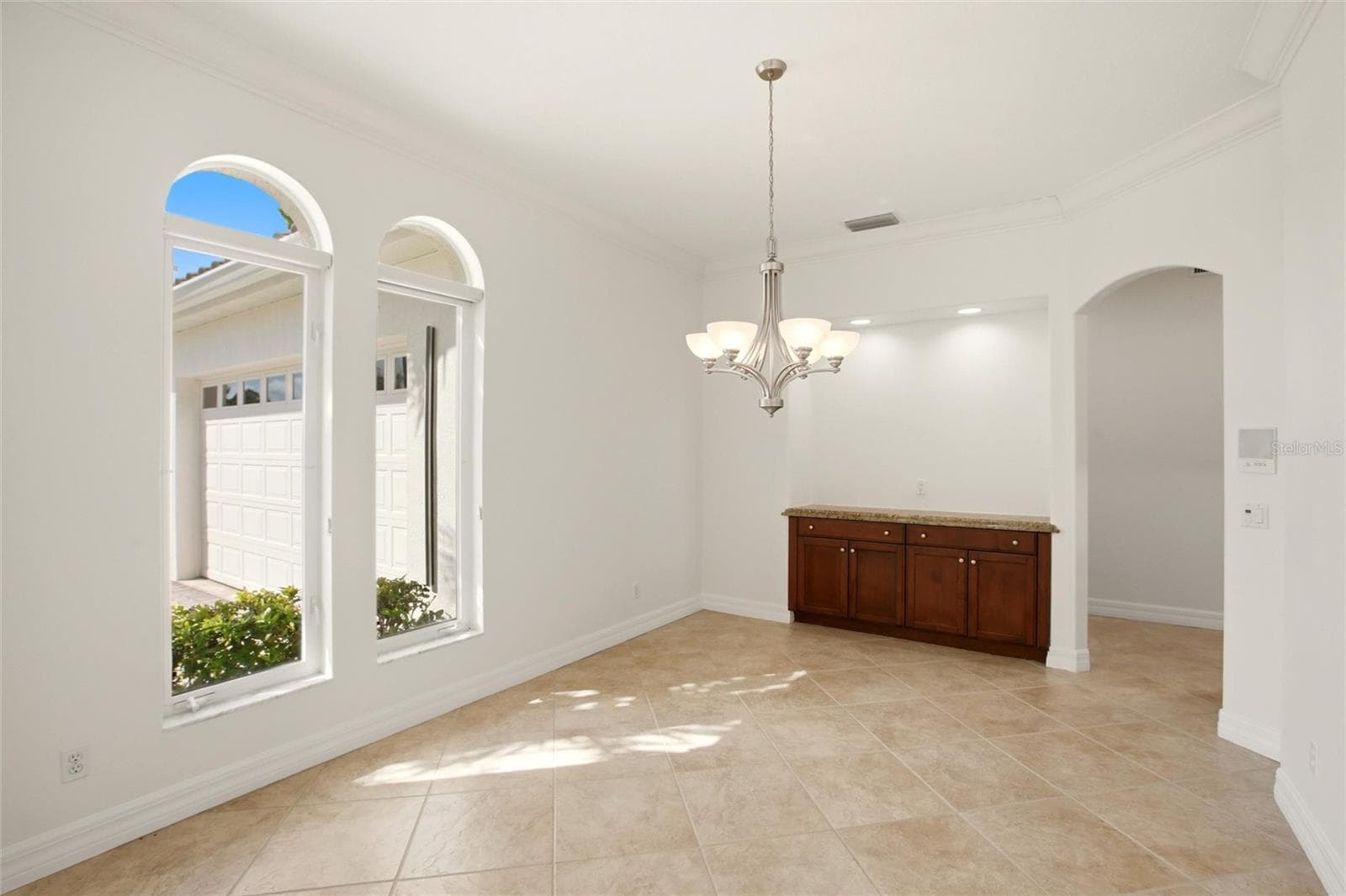 A separate dining room is conveniently located just off the kitchen and features built-in cabinetry, offering both elegance and functional storage. - 8417 LONE EAGLE WAY, SARASOTA