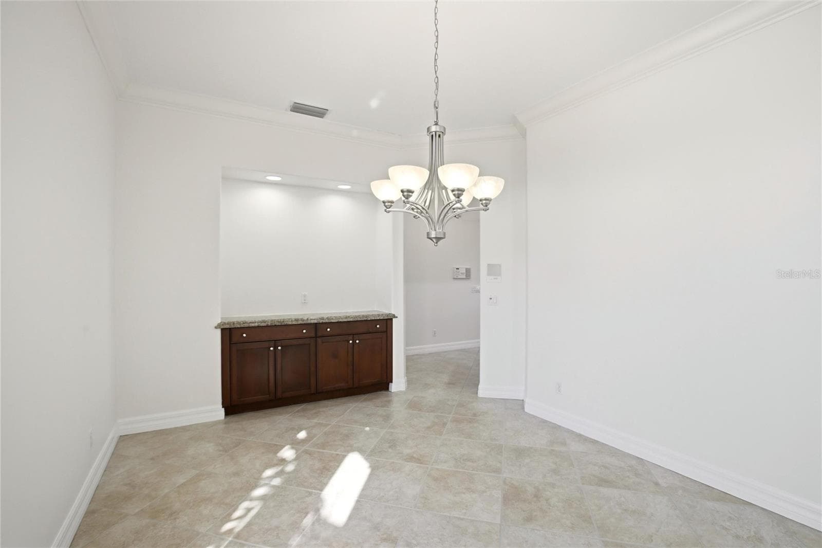 A separate dining room is conveniently located just off the kitchen and features built-in cabinetry, offering both elegance and functional storage. - 8417 LONE EAGLE WAY, SARASOTA