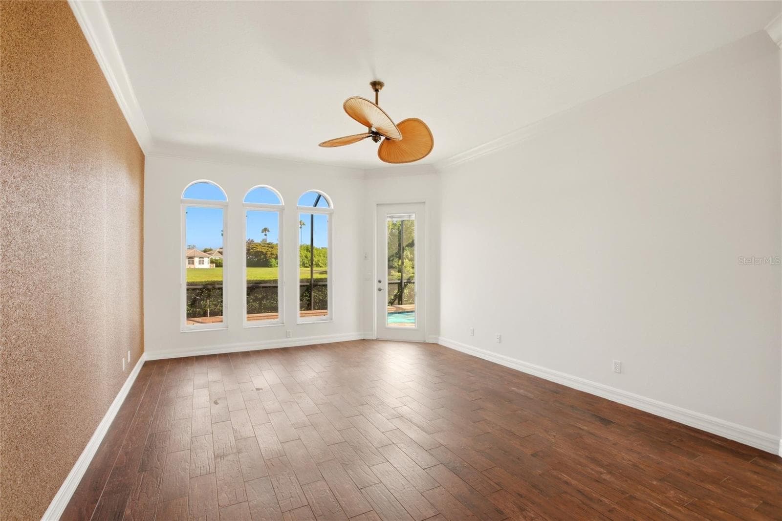 The first-floor primary suite features direct access to the lanai and showcases peaceful views of the lake and pool. - 8417 LONE EAGLE WAY, SARASOTA