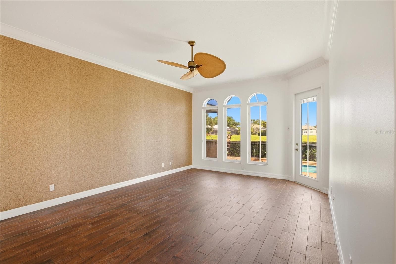 The first-floor primary suite features direct access to the lanai and showcases peaceful views of the lake and pool. - 8417 LONE EAGLE WAY, SARASOTA