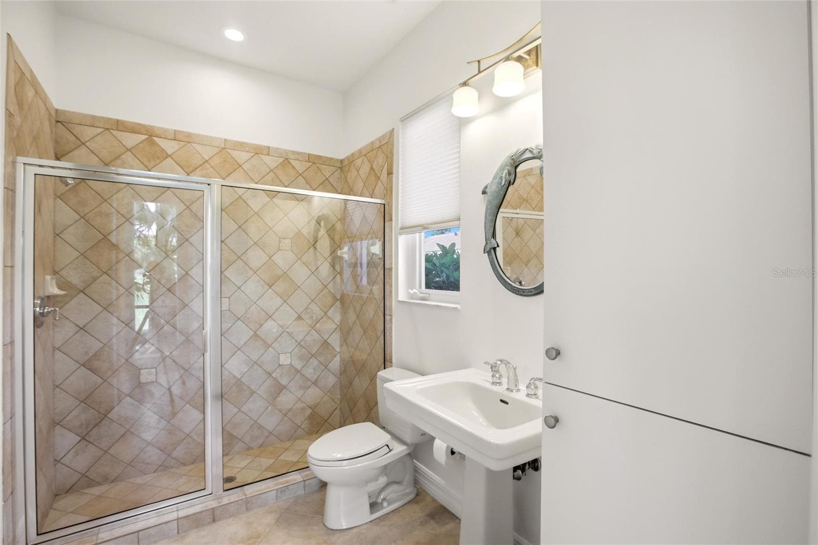 The pool bath is conveniently located by the lanai access and also serves as a versatile first-floor guest bathroom. - 8417 LONE EAGLE WAY, SARASOTA