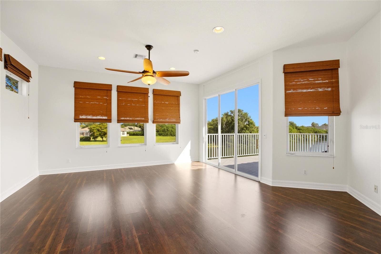 The spacious bonus room offers exceptional versatility, serving as an ideal playroom, guest quarters, media room, or workout space. It is well-appointed with a wet bar, refrigerator, washer and dryer, and a large storage closet, and opens through sliding glass doors to a private second-floor balcony overlooking the lake and golf course. A dumbwaiter provides convenient access from the kitchen below. - 8417 LONE EAGLE WAY, SARASOTA
