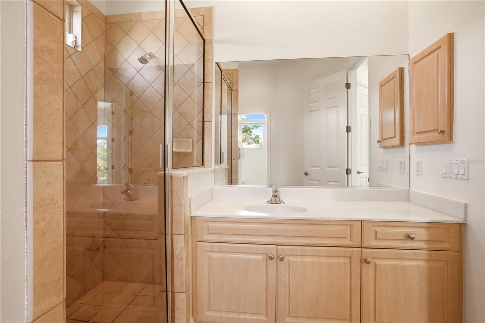 The hall bathroom features a spacious walk-in shower, a sink vanity, a private water closet, and a linen closet, and is conveniently accessible from both the bonus room and the upstairs bedrooms. - 8417 LONE EAGLE WAY, SARASOTA