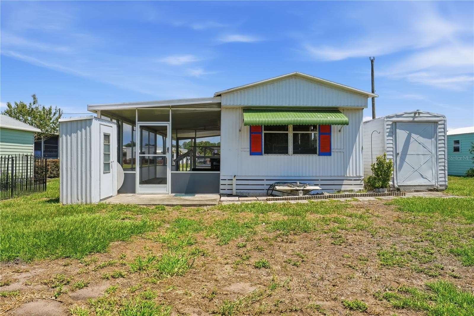 Rear view of home with 2 sheds - 30107 GREEN BAY DR, TAVARES