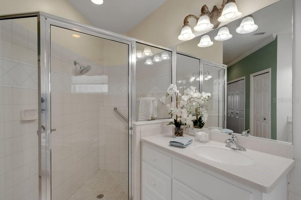 a fully tiled glass enclosed shower. - 684 GRASSLANDS VILLAGE CIR, LAKELAND