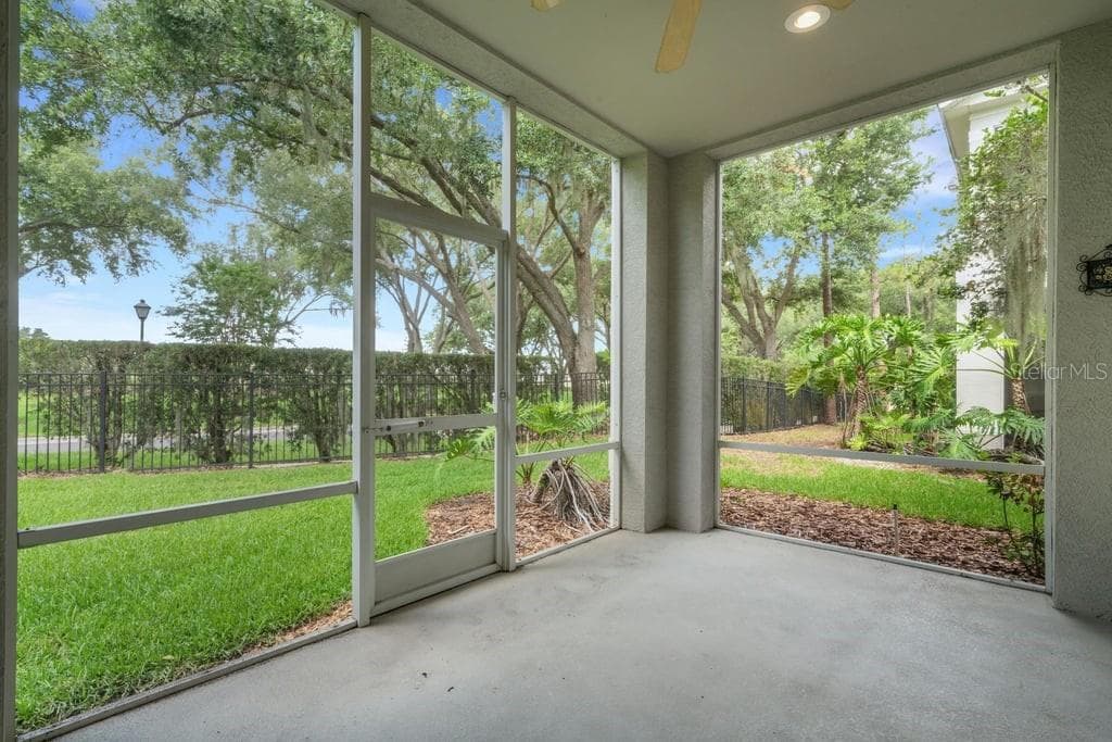 The screen enclosed covered lanai overlooks the greenbelt area behind the building . . . - 684 GRASSLANDS VILLAGE CIR, LAKELAND