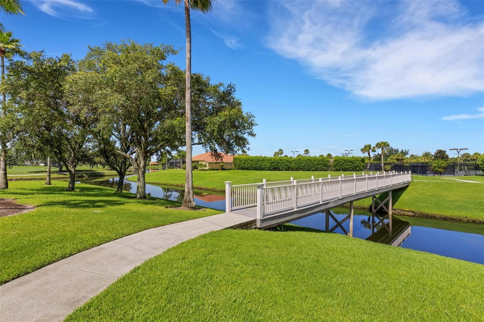 Traverse across the footbridge to the tennis and pickleball courts. - 684 GRASSLANDS VILLAGE CIR, LAKELAND