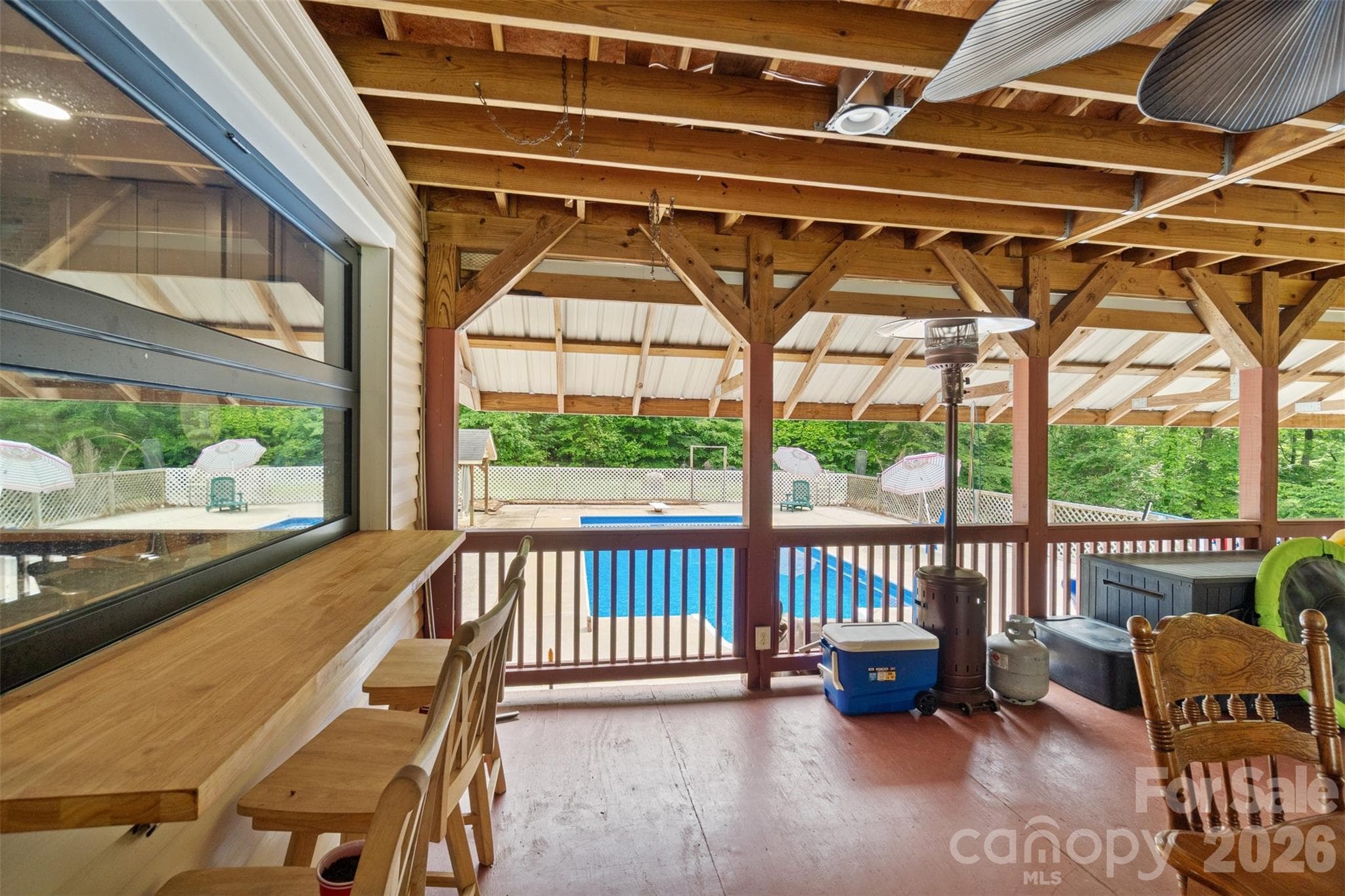 Covered back porch with view of pool - 229 Oakridge Road, Stanley