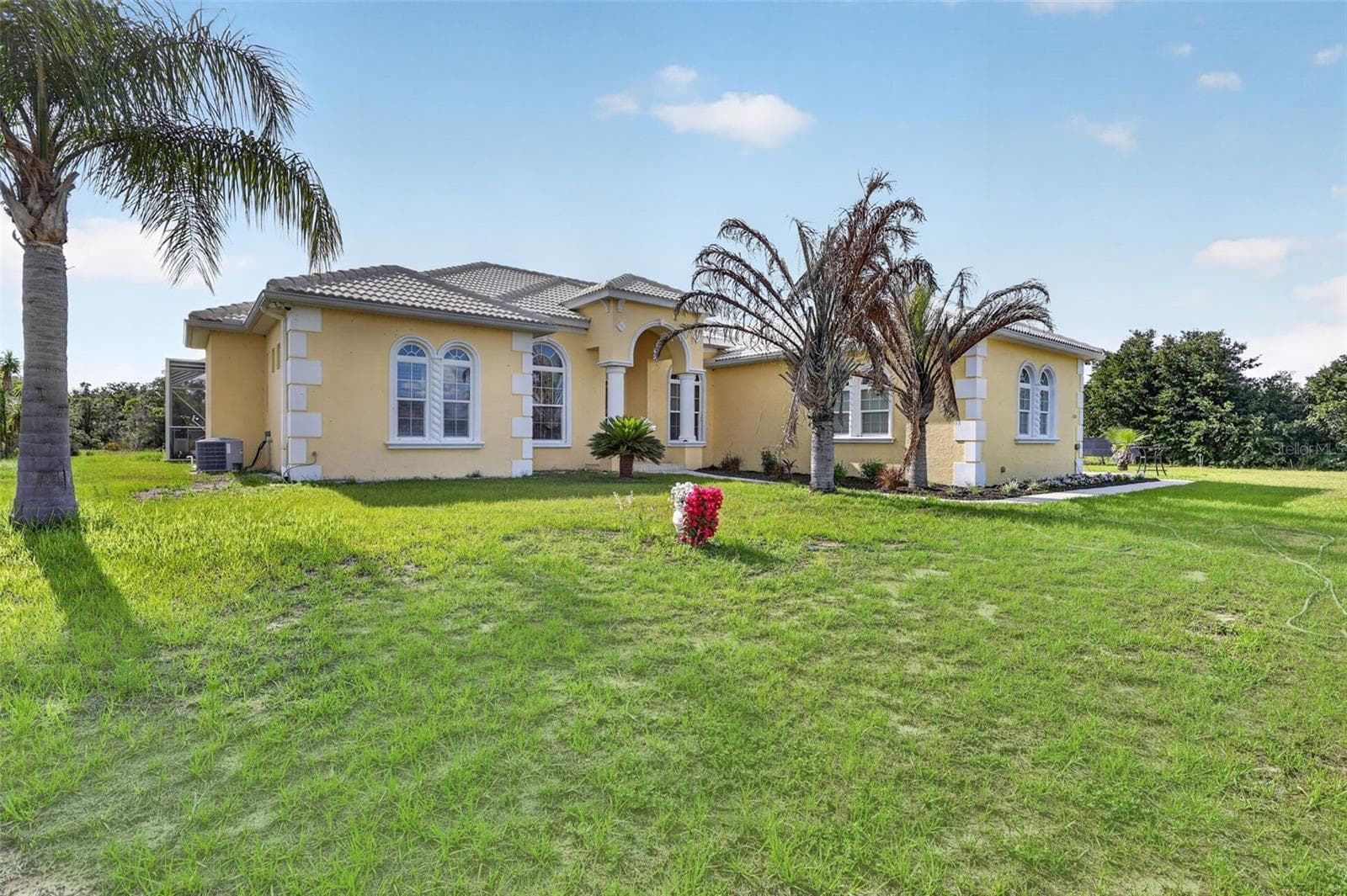 Architecturally distinctive custom-built estate featuring a barrel tile roof, hurricane-impact openings, and nearly six private fenced acres. - 1210 408TH CT E, MYAKKA CITY