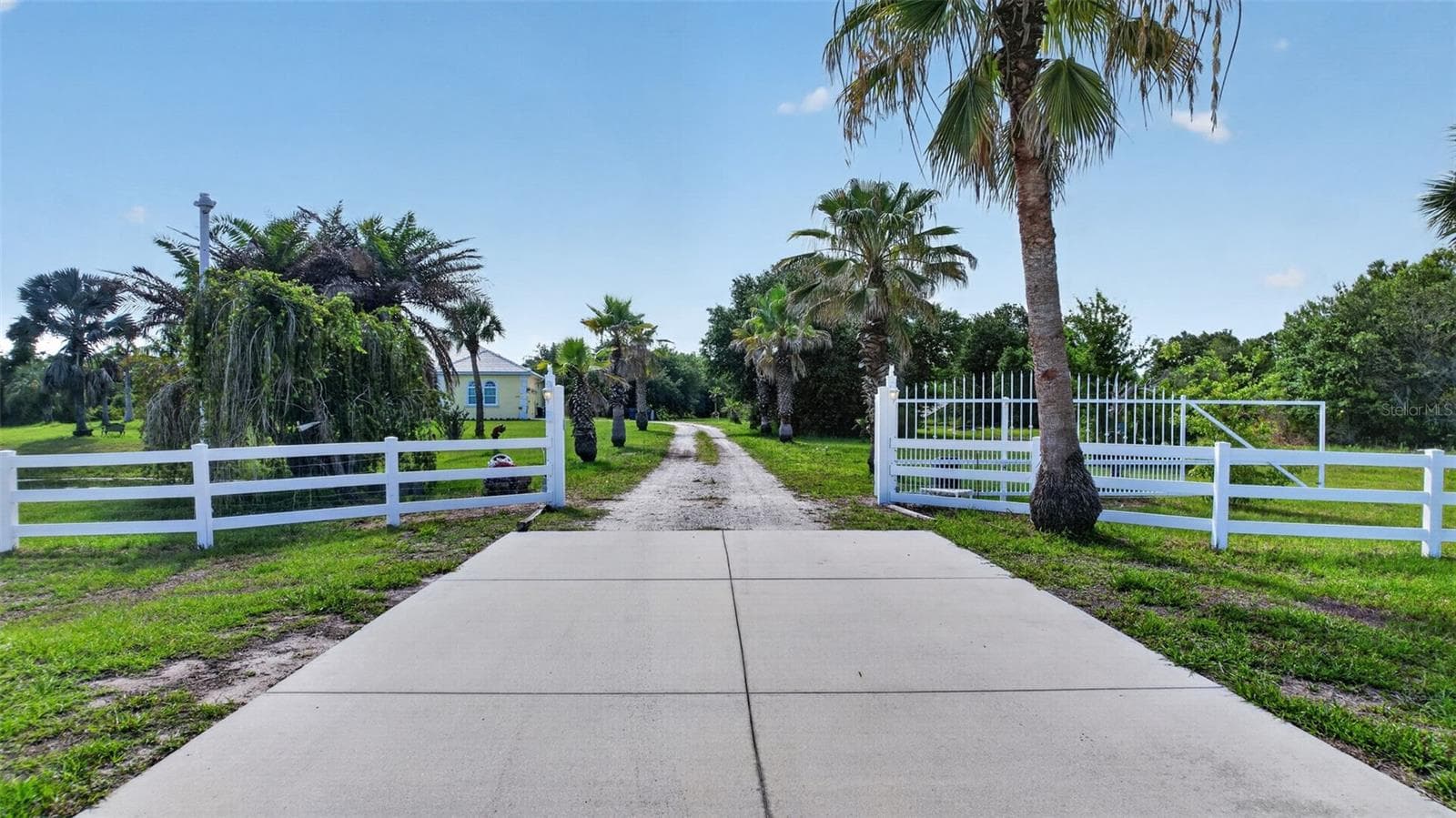 Enter through the private coded motorized gate and experience the privacy, security, and expansive grounds this exceptional estate offers. - 1210 408TH CT E, MYAKKA CITY