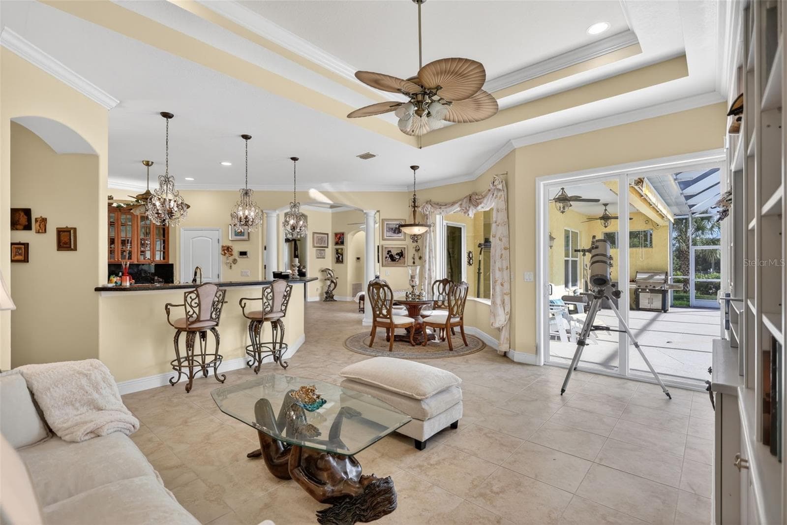 The heart of the home offers exceptional flow between the kitchen, casual dining area, family room, and outdoor living spaces, creating an ideal environment for gatherings. - 1210 408TH CT E, MYAKKA CITY
