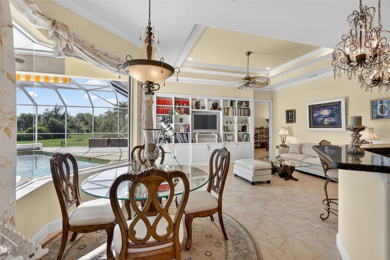 Enjoy tranquil views of the pool and surrounding acreage from the breakfast area, perfectly positioned within the home's spacious and functional floor plan. - 1210 408TH CT E, MYAKKA CITY