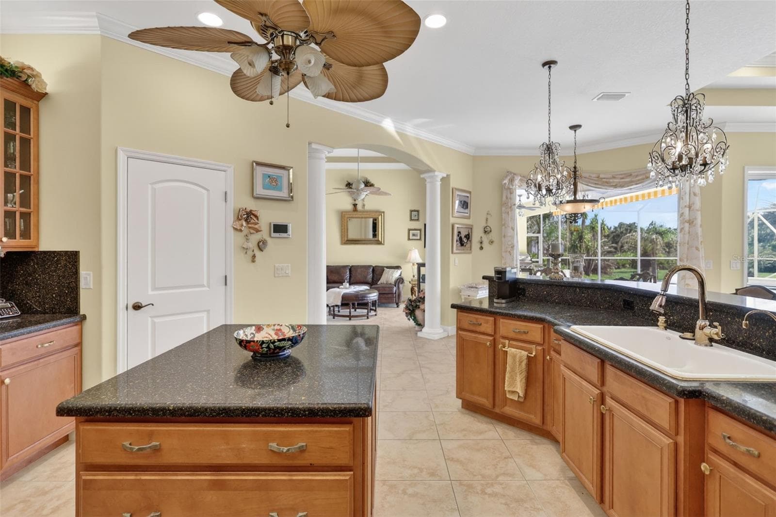 Designed for both functionality and entertaining, the oversized kitchen features generous counter space, a center island, pantry storage, and easy access to the adjacent dining and living areas. - 1210 408TH CT E, MYAKKA CITY