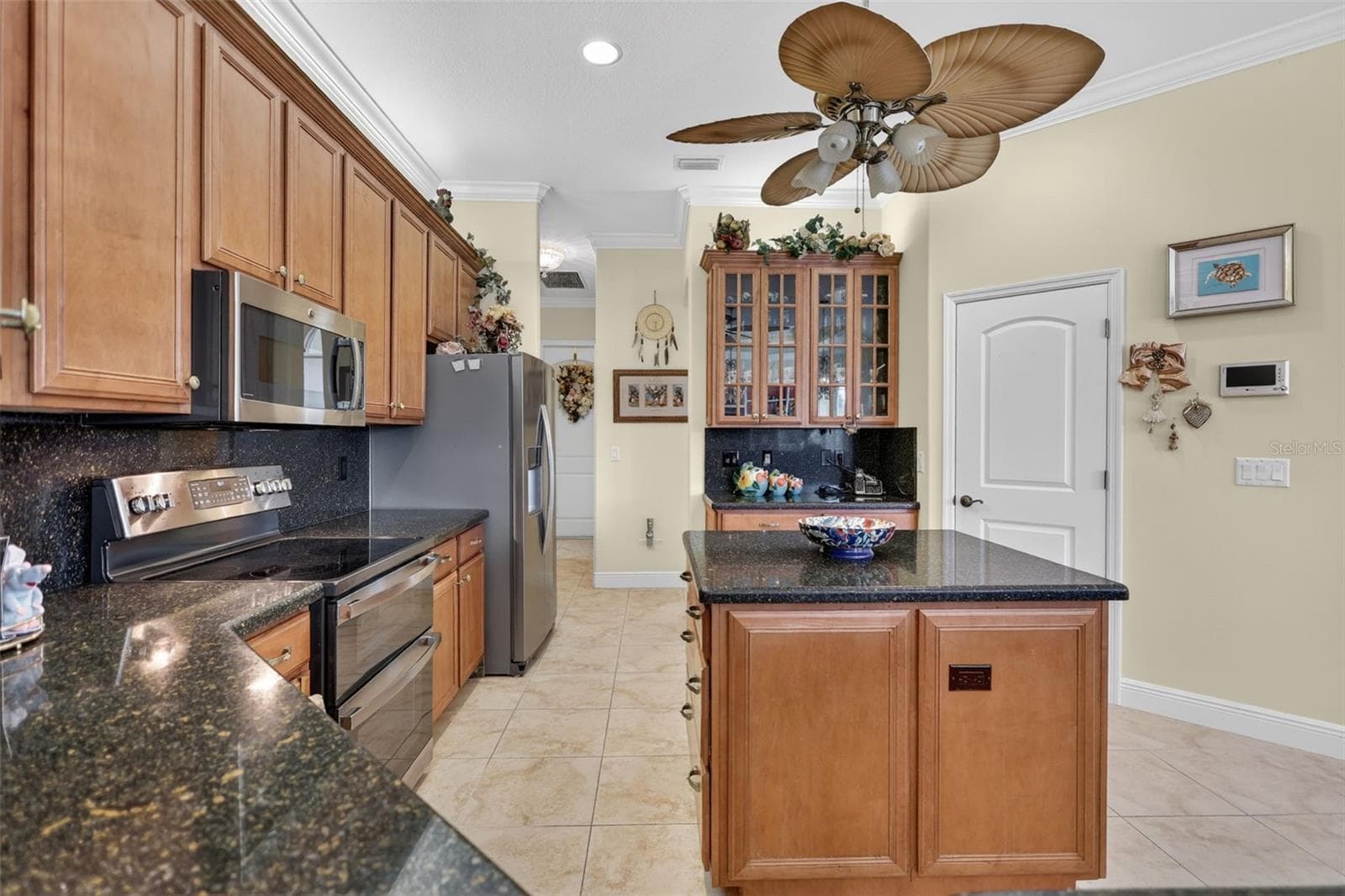 The well-appointed kitchen combines abundant cabinetry, ample prep space, and an efficient layout ideal for everyday living and hosting guests. - 1210 408TH CT E, MYAKKA CITY