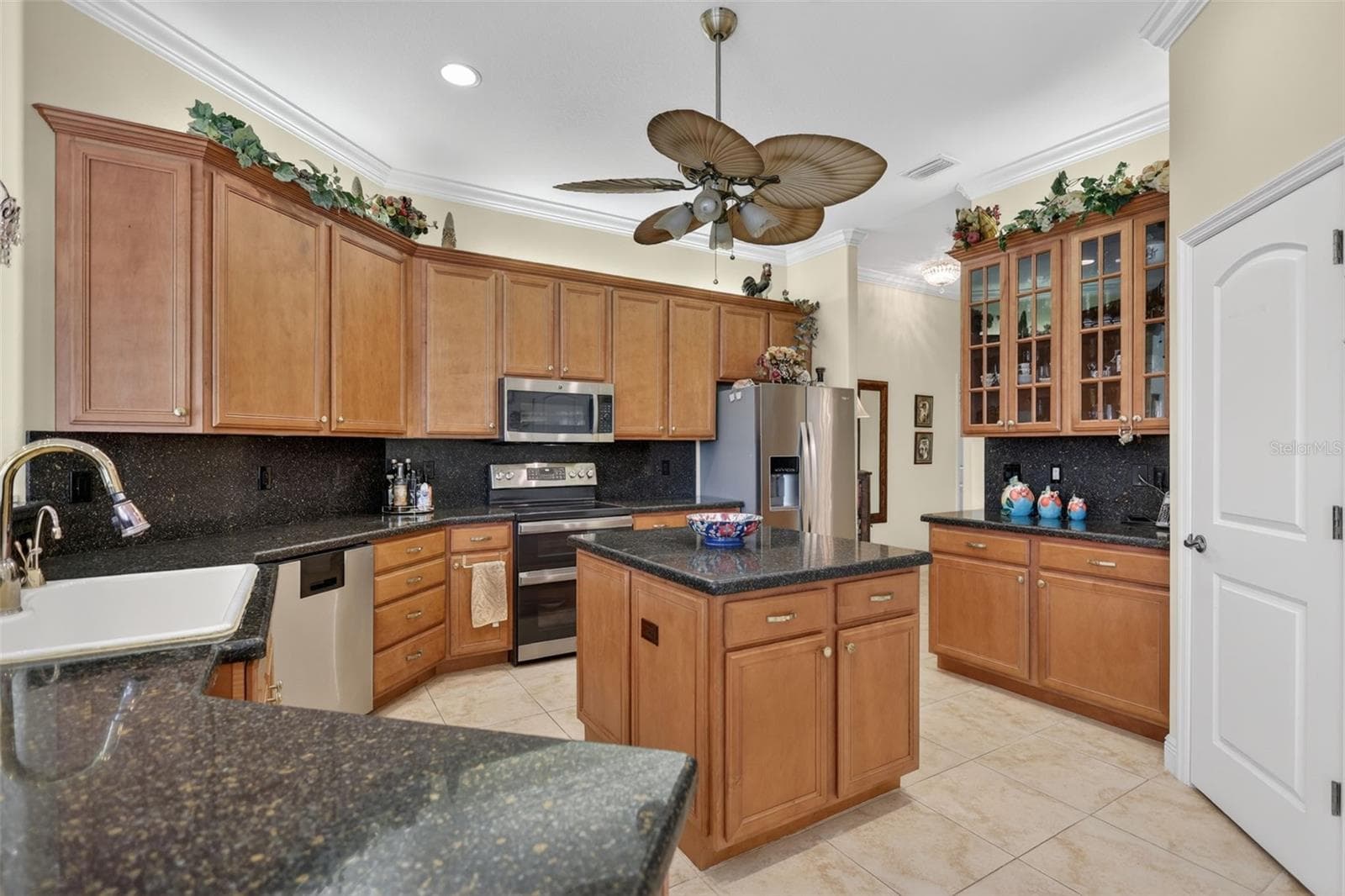 The formal living room and entry foyer highlight the home's grand scale with soaring ceilings, custom architectural details, and a thoughtfully designed floor plan. - 1210 408TH CT E, MYAKKA CITY
