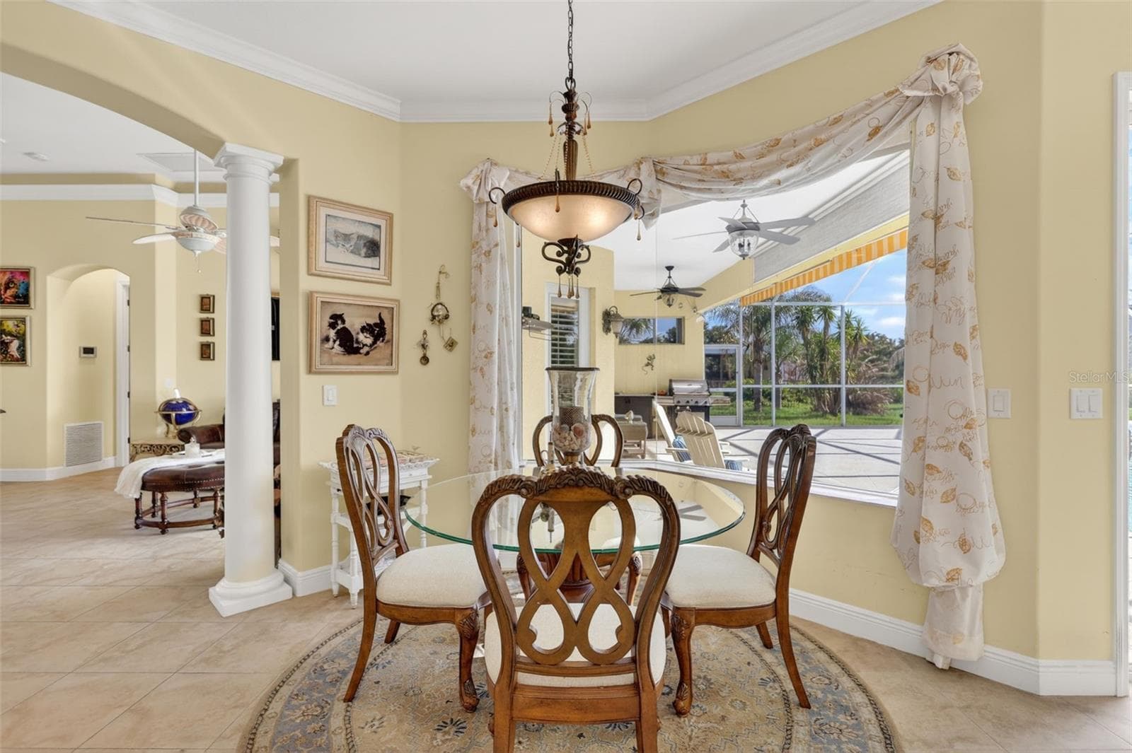 The sunny breakfast nook offers the perfect place to enjoy morning coffee while overlooking the pool, lanai, and scenic acreage beyond. - 1210 408TH CT E, MYAKKA CITY