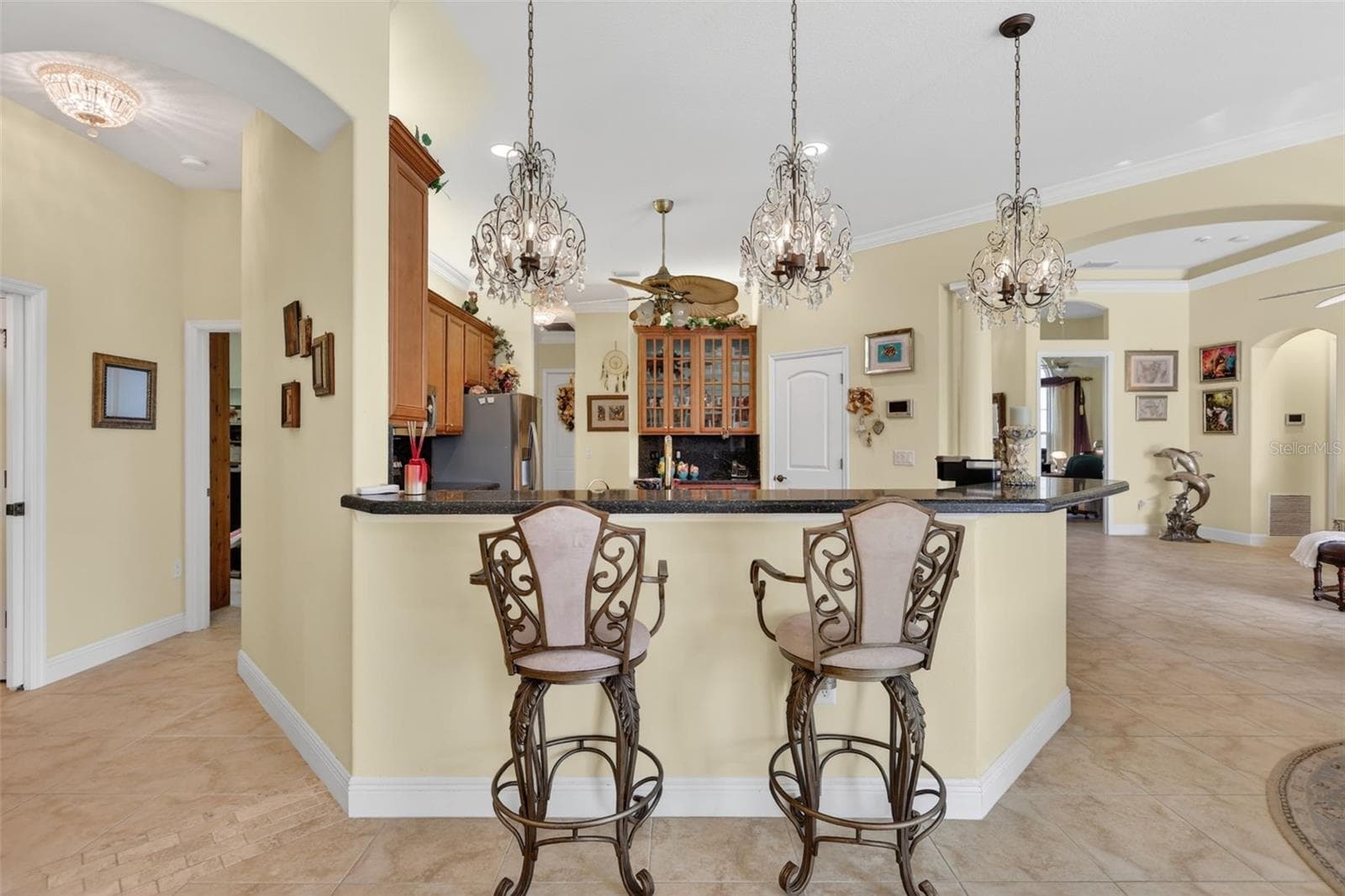 The expansive breakfast bar and open-concept layout create an ideal setting for entertaining, with effortless flow between the kitchen and living areas. - 1210 408TH CT E, MYAKKA CITY