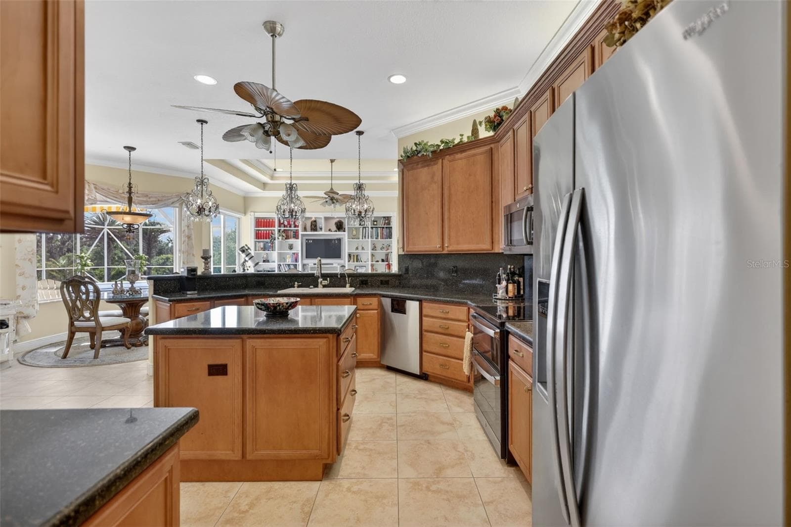 Enjoy beautiful views from the kitchen while preparing meals in this spacious and thoughtfully designed gathering space. - 1210 408TH CT E, MYAKKA CITY