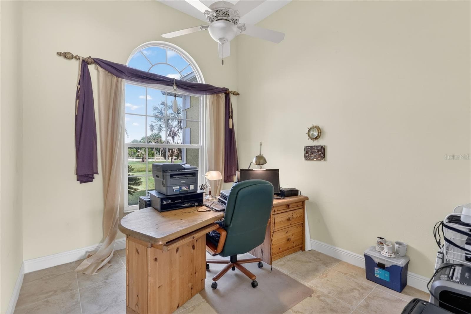 The private office provides a quiet and comfortable workspace with soaring ceilings, abundant natural light, and peaceful views of the property. - 1210 408TH CT E, MYAKKA CITY