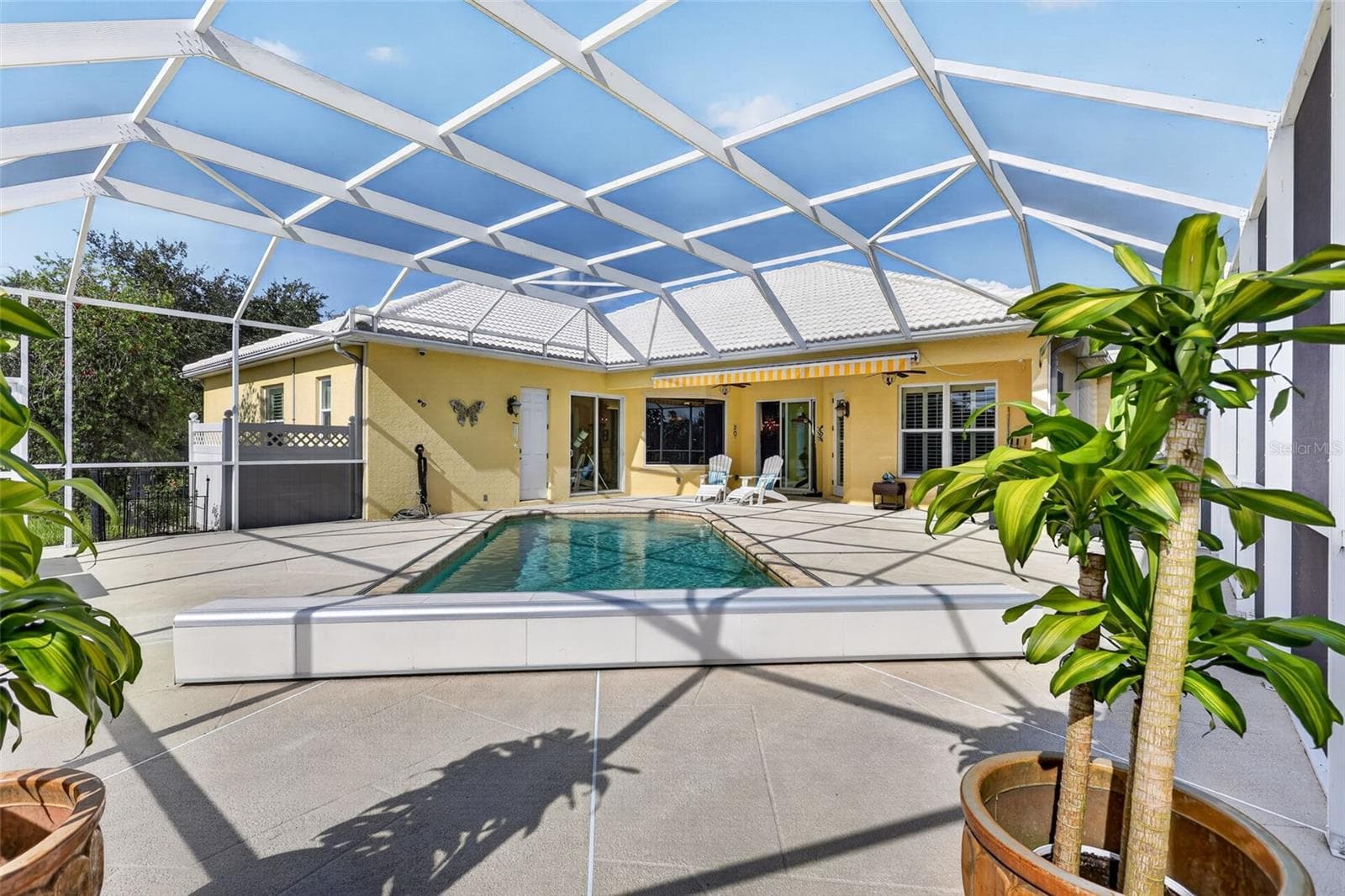 From every angle, the resort-style pool area showcases the home's seamless blend of indoor comfort and outdoor living. - 1210 408TH CT E, MYAKKA CITY