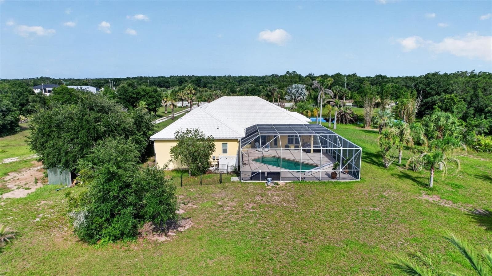 Surrounded by lush greenery and open acreage, this estate offers a peaceful retreat while still providing convenient access to nearby amenities. - 1210 408TH CT E, MYAKKA CITY