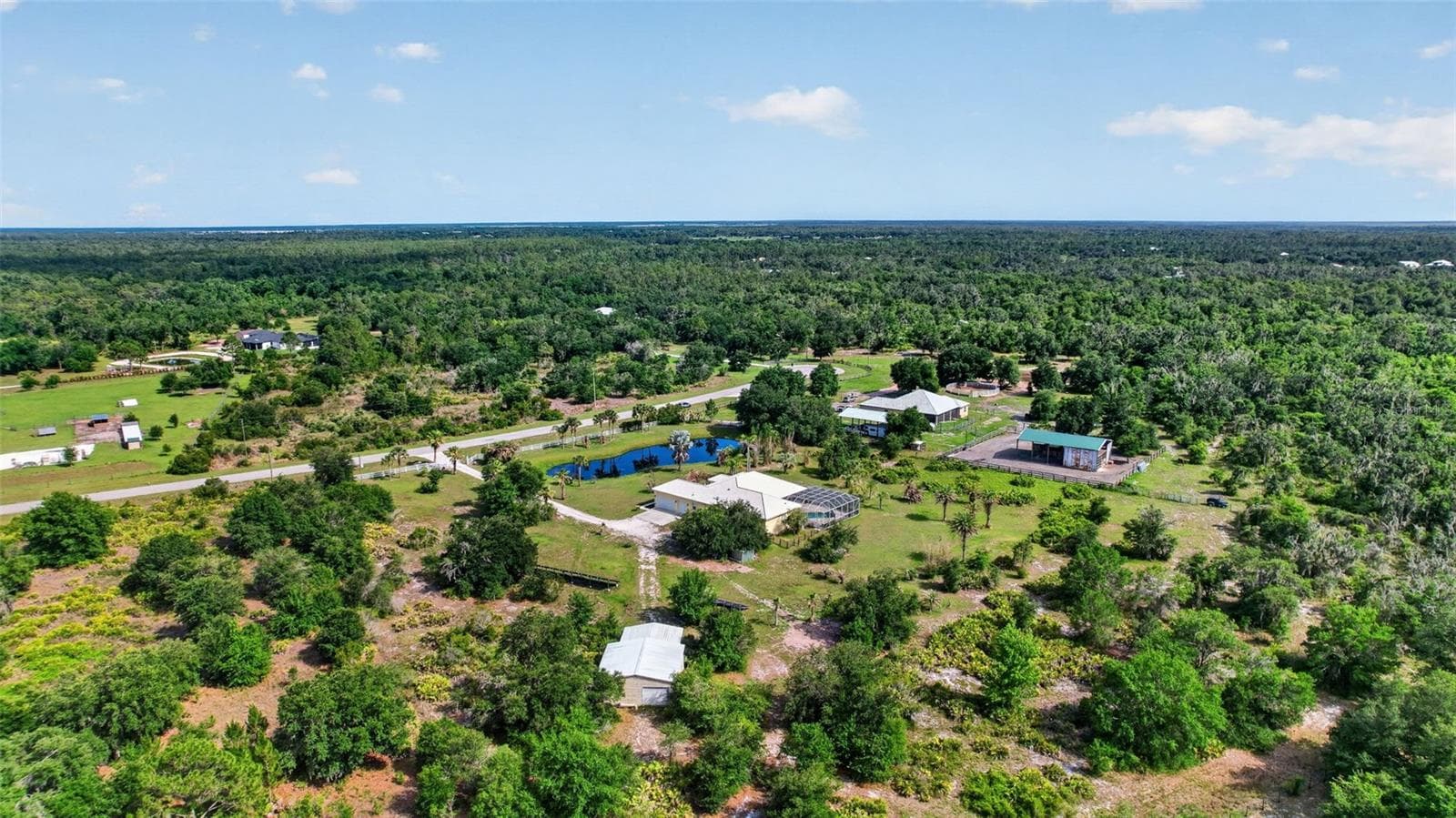 The estate's expansive grounds, mature trees, and open spaces offer endless possibilities for recreation, gardening, animals, or future enhancements. - 1210 408TH CT E, MYAKKA CITY