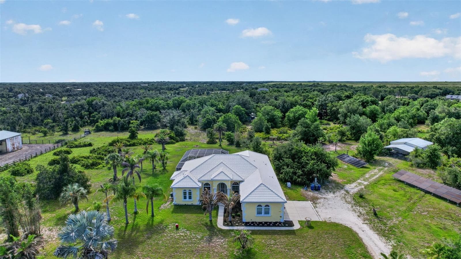 Rare opportunity to own a private, horse-friendly estate featuring nearly six acres, owned solar, extensive infrastructure upgrades, and room for recreation, hobbies, and animals. - 1210 408TH CT E, MYAKKA CITY