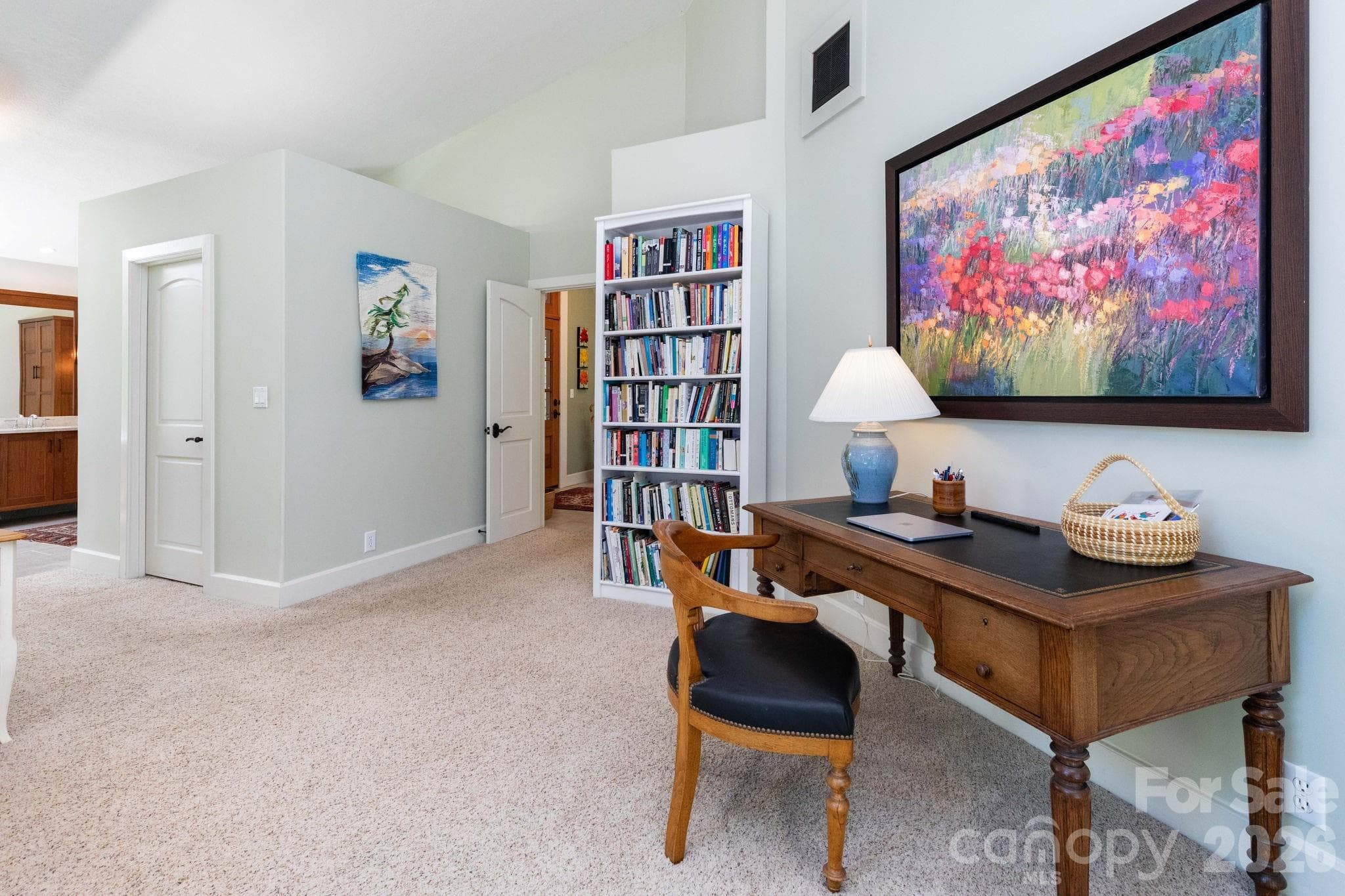 Expansive primary suite featuring a dedicated sitting area, soaring ceilings, and abundant natural light, creating a peaceful private retreat with space to relax, read, or work from home. - 29 Gardner Drive, Asheville