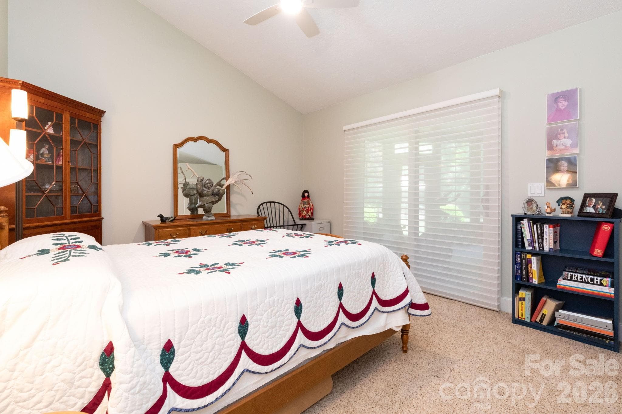 Bright and airy bedroom with vaulted ceilings, oversized windows, and sliding glass doors that seamlessly connect the interior to the three-season screened patio and surrounding natural beauty. - 29 Gardner Drive, Asheville