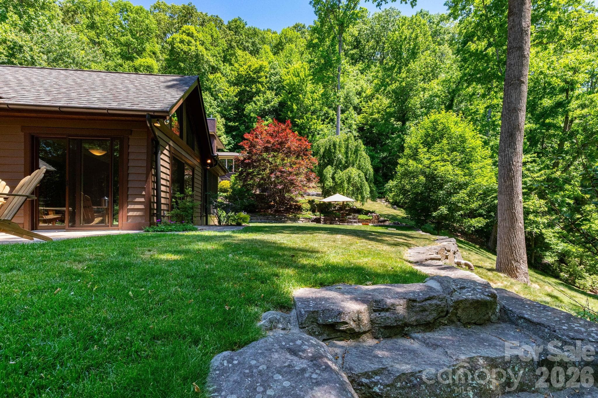 Professionally landscaped grounds featuring layered stonework, natural rock outcroppings, and beautifully maintained gardens. - 29 Gardner Drive, Asheville