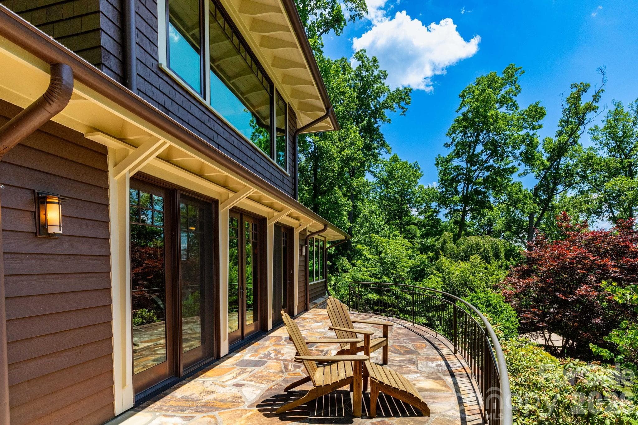 Guest House. Private curved stone terrace offers a peaceful outdoor escape for morning coffee, quiet reflection, or enjoying the surrounding mountain scenery. - 29 Gardner Drive, Asheville