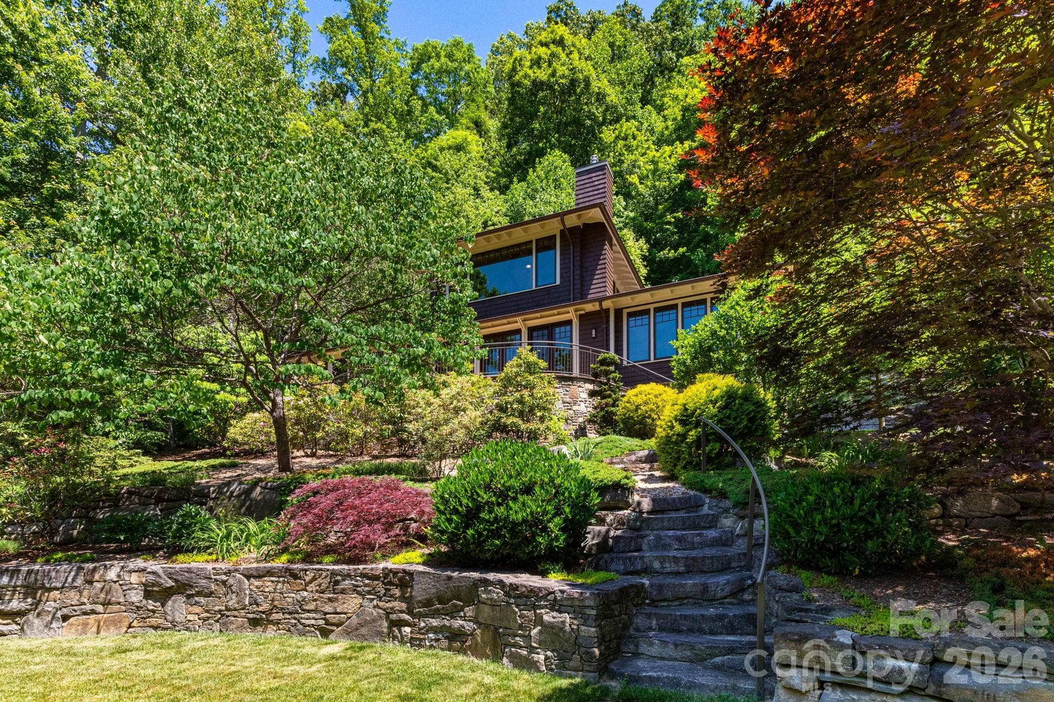 Guest House. Tucked into beautifully landscaped grounds and surrounded by lush forest, this architecturally distinctive guest house offers a rare sense of peace, privacy, and connection to nature. - 29 Gardner Drive, Asheville