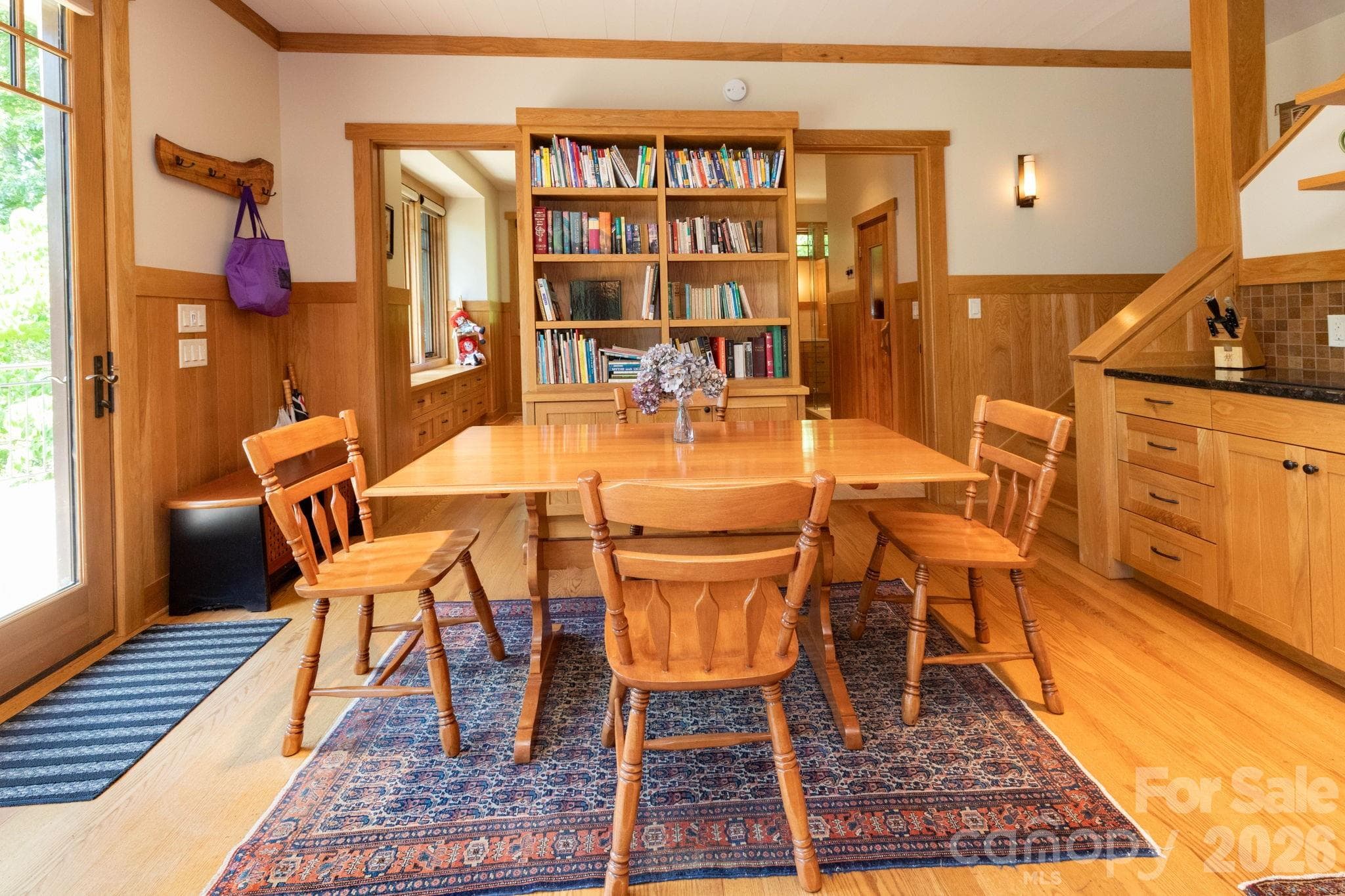 Guest House. Charming dining area with built-in shelving and seamless flow into the living spaces, designed for comfort and connection. - 29 Gardner Drive, Asheville