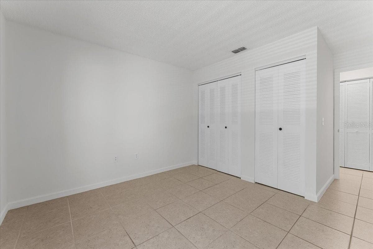 Bedroom 2 with dual closets - 3001 58TH AVE S #1106, ST PETERSBURG
