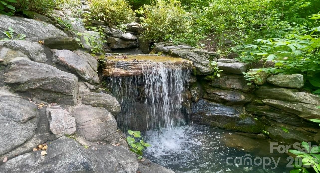 Private waterfall and tranquil sitting pool surrounded by lush native landscaping, creating a peaceful retreat immersed in nature. - 29 Gardner Drive, Asheville
