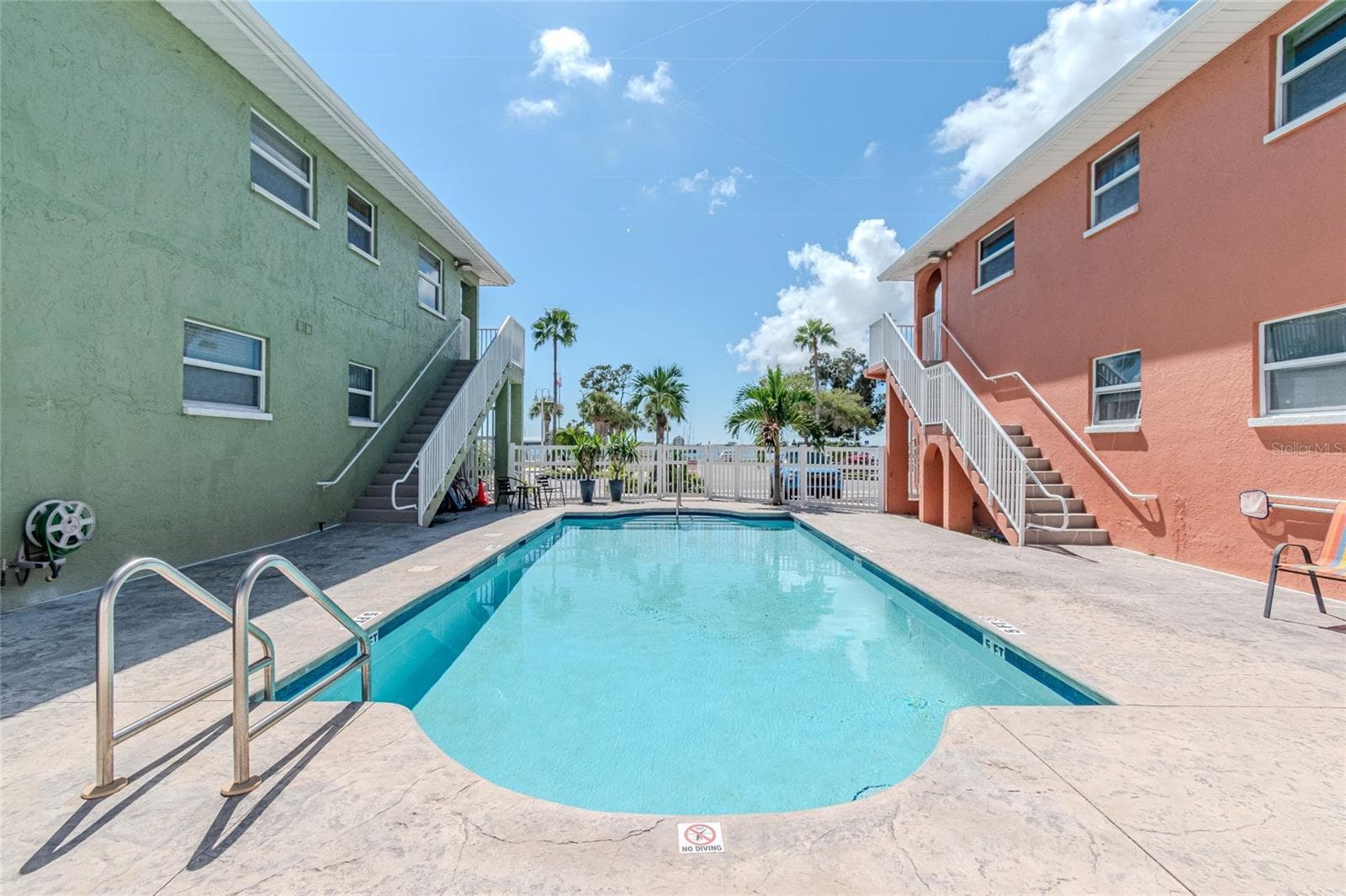 VIEW OF POOL BETWEEN THE BLDGS. - 5605 SHORE BLVD S #1B, GULFPORT